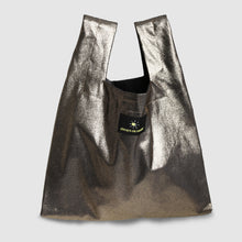 Metallic gold bag with a brand logo on a light gray background


