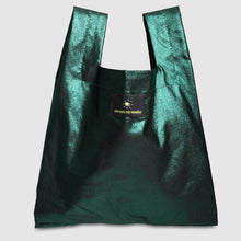 Green shiny bag on a light gray background

